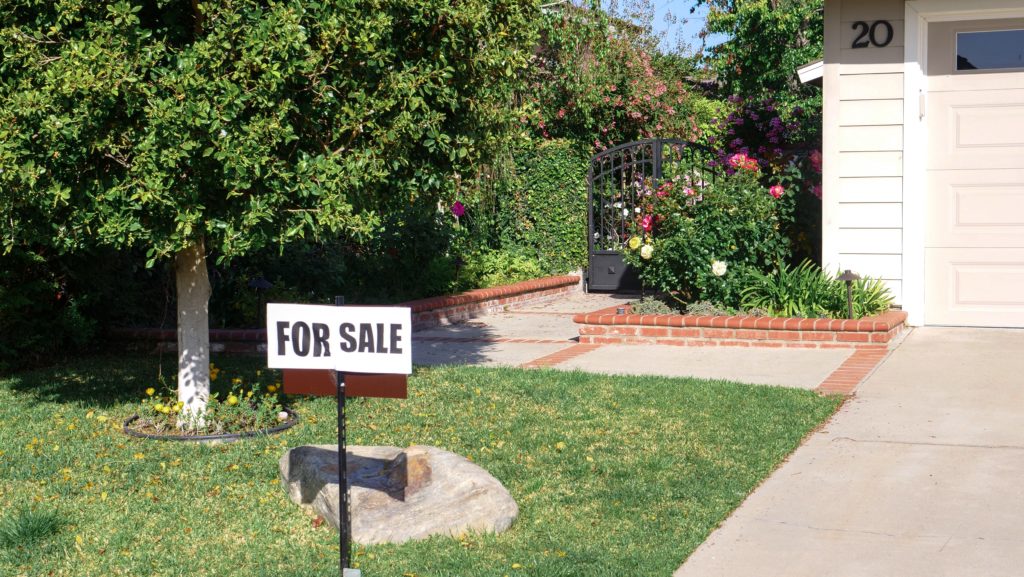 For sale sign in front of home